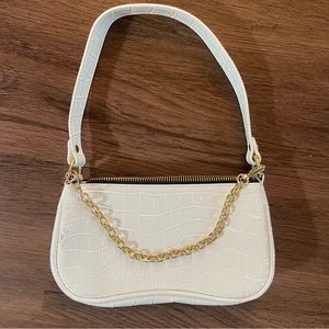 white purse with gold chain